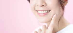 A close-up shot of a woman's smile after getting a bone graft in Houston